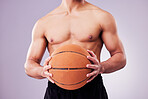 Hands, basketball and a shirtless sports man in studio on a gray background for training or a game. Exercise, workout or body and a male athlete holding a ball while posing topless for fitness
