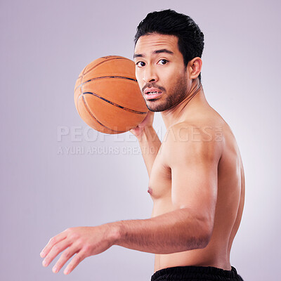 Buy stock photo Portrait, playing basketball and a sports man in studio on a gray background for training or a game. Exercise, workout or mindset and a young male athlete holding a ball to play a competitive match