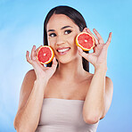 Woman thinking, happy skincare and grapefruit for beauty, cosmetics, natural product and tropical facial or vitamin c. Young person or model with red fruits for dermatology on blue, studio background