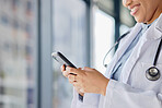 Hands of doctor, woman and typing on smartphone in hospital for online contact, reading healthcare data and telehealth information. Closeup of medical worker search mobile app, technology and network