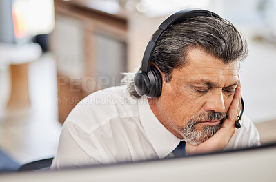 Buy stock photo Fatigue, sleep and male call center consultant in his office while doing online consultation. Exhausted, burnout and tired mature man telemarketing or customer support agent with headset in workplace
