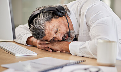 Buy stock photo Tired, customer service and male agent sleeping in his office while doing online consultation. Exhausted, burnout and mature man telemarketing or call center consultant taking a nap in the workplace.