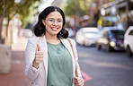Business woman, thumbs up and portrait in the city, street or professional worker with success, agreement or thank you. Hand, sign and happy worker in urban, town or walking to office building
