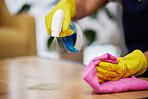 Spray, hands and person cleaning table, furniture and housekeeping services at home. Closeup of cleaner wipe surface with cloth, bottle of chemical product and disinfection of dust, bacteria and dirt
