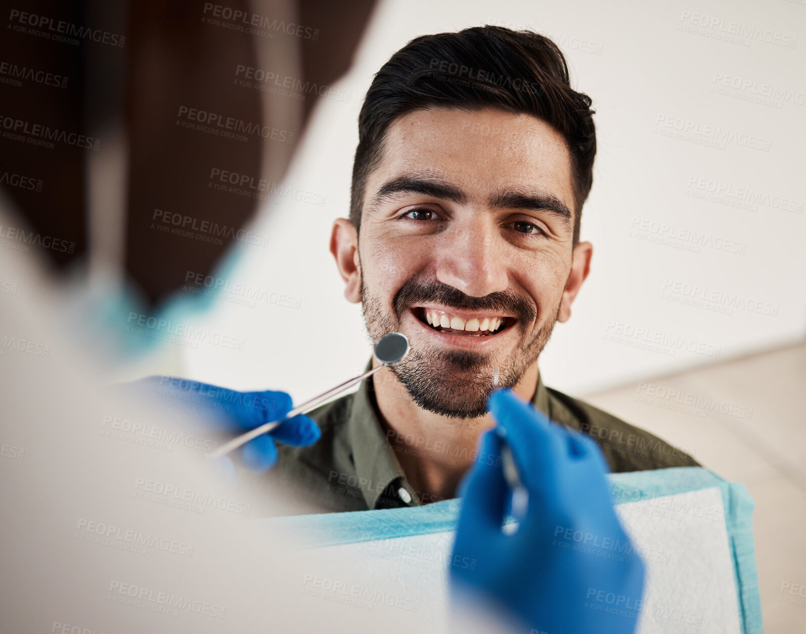 Buy stock photo Portrait, man and hands of dentist with tools for dental, healthcare or check in clinic. Face smile, orthodontics and patient with doctor, mirror and excavator for teeth cleaning and medical hygiene