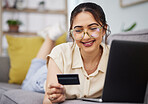 Woman, credit card and finance with laptop on sofa for digital payment, fintech password and online shopping. Happy female customer, computer and banking code for financial sales investment at home 