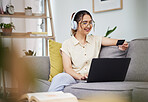 Woman, credit card and laptop with headphones in home for digital payment, fintech password and online shopping. Happy female customer, computer account and banking code to upgrade music subscription