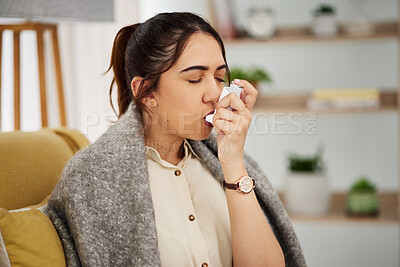 Buy stock photo Sick, breathing and woman with a pump for asthma, medical emergency or spraying air into mouth. House, covid and a young girl with risk for healthcare, lung support or inhaler on the sofa in her home