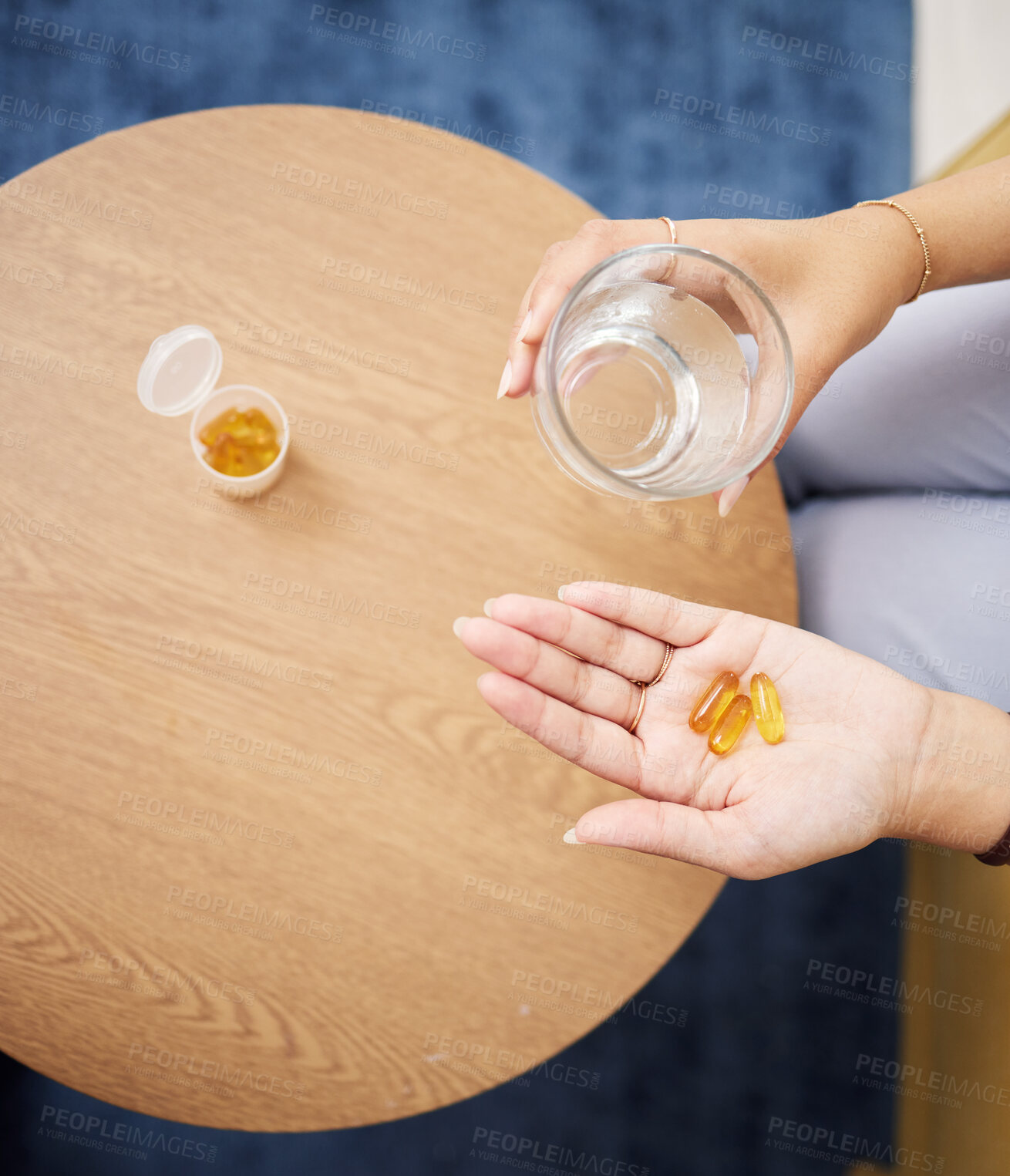 Buy stock photo Top view of hands, pills and water in glass for sick woman, iron supplements and cure at home. Capsule tablets, prescription drugs and vitamins in palm for wellness product, medicine and healthcare