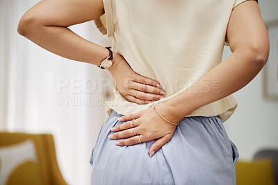 Buy stock photo Back pain, hands and woman in a living room with problem, discomfort or arthritis in her home. Backache, spine and person with cramps, joint or posture in lounge with osteoporosis or fibromyalgia