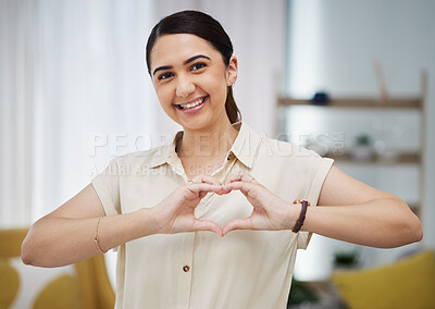 Buy stock photo Portrait, heart and hands of woman in home for care, charity and kindness on valentines day. Happy female person with finger shape for love icon, thank you and emoji in support of freedom in lounge