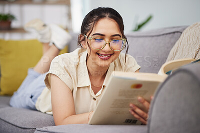 Buy stock photo Happy woman, reading and book on sofa in home for story, novel and studying literature. Young student, gen z girl and relax with books in lounge for learning, knowledge and education in living room