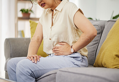 Buy stock photo Sick woman, sofa and stomach pain for health, digestion and nausea of pms at home. Closeup of female person, menstruation and abdomen bloating of constipation, period and endometriosis in living room