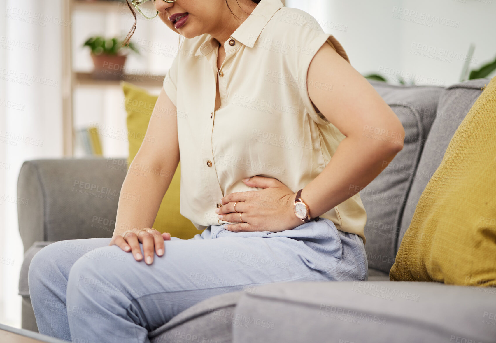 Buy stock photo Sick woman, sofa and stomach pain for health, digestion and nausea of pms at home. Closeup of female person, menstruation and abdomen bloating of constipation, period and endometriosis in living room