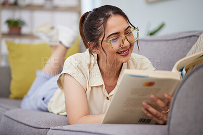 Buy stock photo Woman, sofa and reading book in living room for story, novel and learning knowledge. Happy female student, gen z girl and relax with books in lounge for studying, literature or hobby to enjoy at home