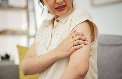 Buy stock photo Shoulder, injury and hand of woman on sofa with problem, arthritis or osteoporosis in her home. Arm, pain and female with joint, crisis or fibromyalgia in living room with muscle tension or accident