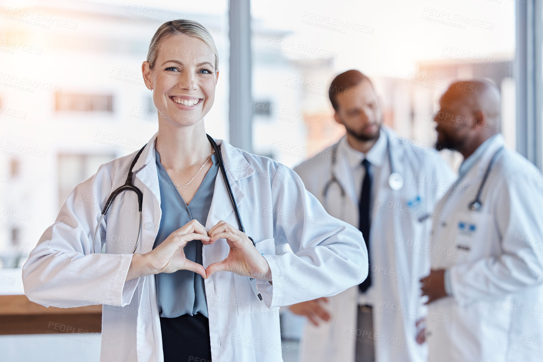 Buy stock photo Healthcare, heart and hands with portrait of doctor in hospital for medical, support and kindness. Motivation, wellness and medicine with woman and gesture in clinic for cardiology, care and emoji