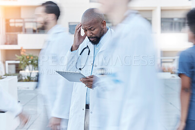 Buy stock photo Tablet, doctor and black man with headache in busy hospital, fatigue or burnout. Tech, medical professional or person with problem, crisis or challenge, stress or anxiety in mistake, fail or disaster