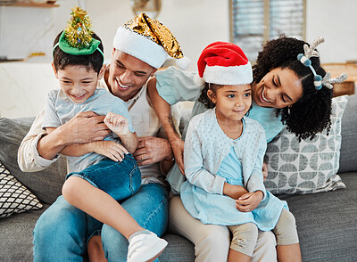 Buy stock photo Parents, kids and playing on sofa, christmas or tickling with comic laughing, game or excited in family home. Mother, father and happy young children with xmas celebration, relax and bonding or couch