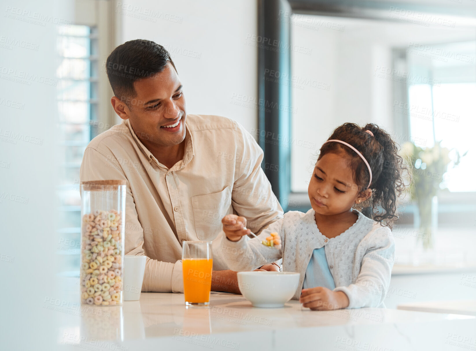 Buy stock photo Happy, morning and a child with father for breakfast, food in a kitchen and care for nutrition at home. Smile, together and a young dad with a girl kid eating cereal in a house for health and hungry