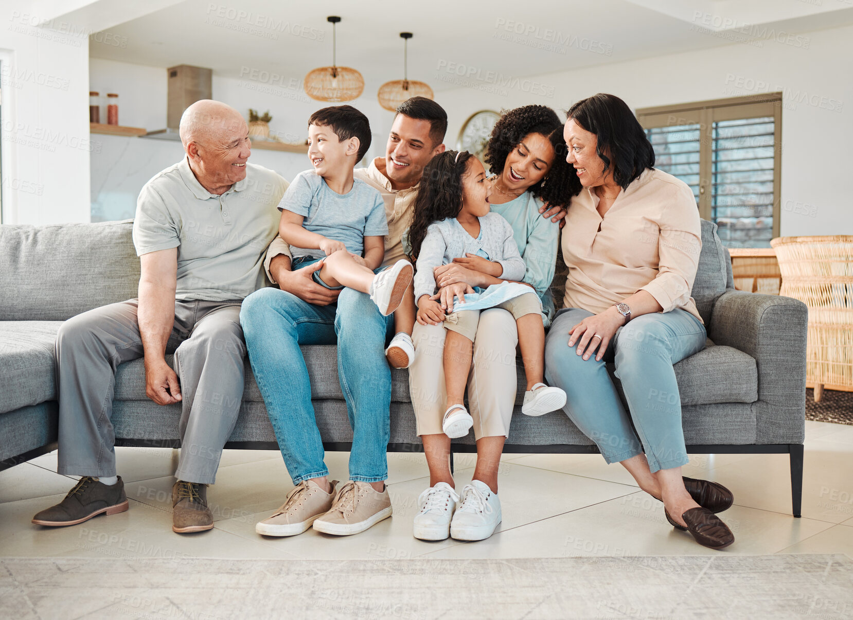 Buy stock photo Relax, laugh and generations of family on sofa together, support and love in new home or apartment. Men, women and children on couch, happy smile with grandparents, parents and kids in living room.