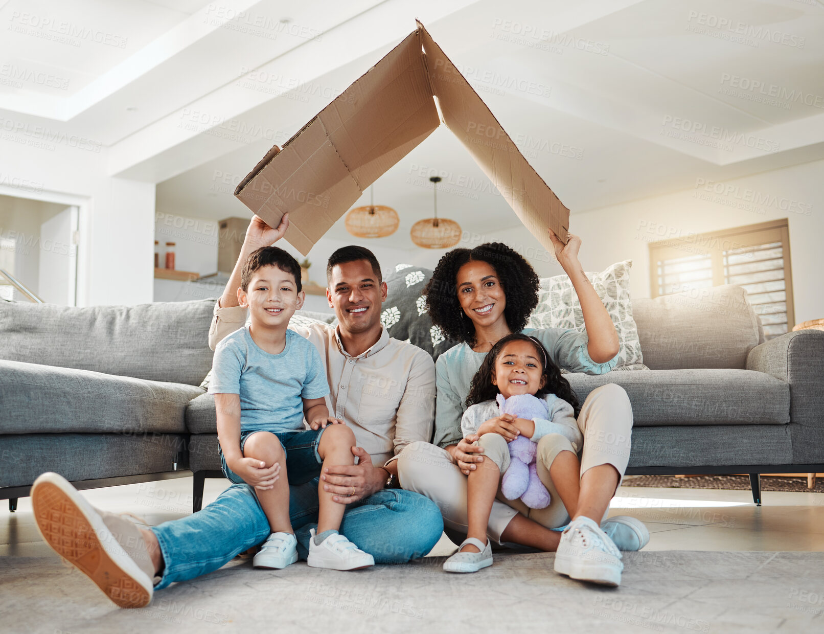 Buy stock photo Cardboard roof, portrait and a family in a home for security, safety and shelter as a family. Happy, house and a mother, father and children with refuge in a living room for insurance together