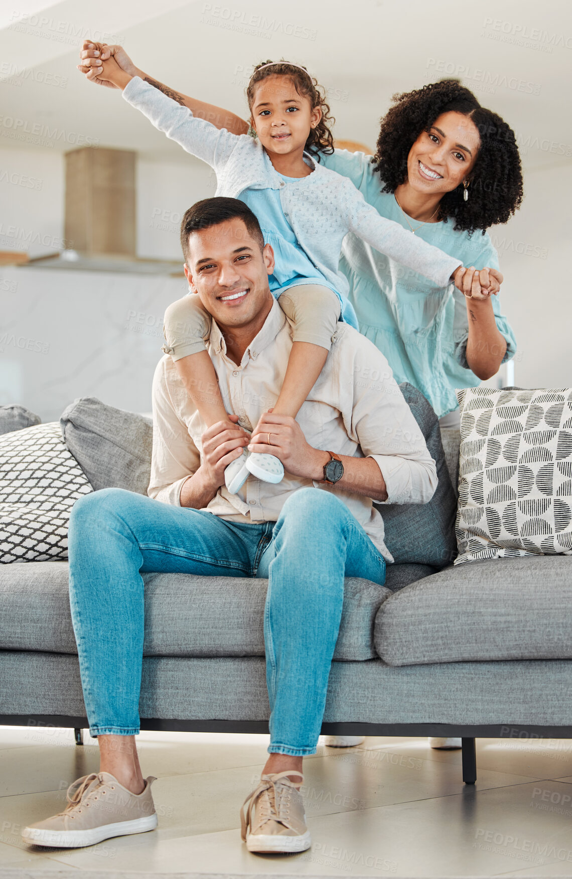 Buy stock photo Portrait, smile and family on sofa in home living room, bonding and relax together. Interracial, happy and father, mother and child, girl or kid in piggyback, play game and quality time in house.