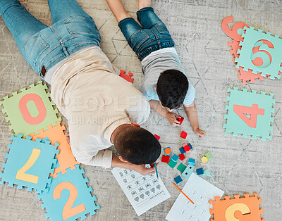 Buy stock photo Building blocks, top or father with kid on the floor for learning, education or child development at home. Family, play or dad enjoying bonding time in living room with boy or toys doing homework