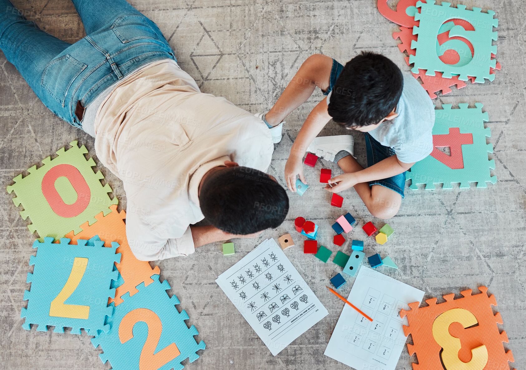 Buy stock photo Building blocks, above or father with kid on the floor for learning, education or child development at home. Family, play or dad enjoying bonding time in living room with boy or toys doing homework