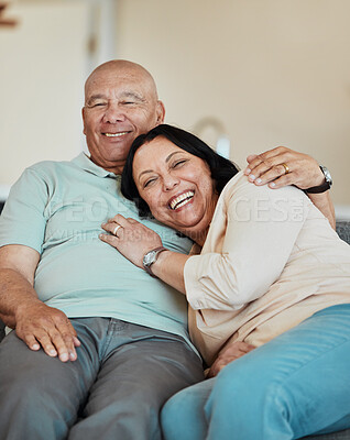 Buy stock photo Funny, portrait and senior couple in home living room, bonding and relax together for retirement. Face, laughing and elderly man and woman hug on sofa in lounge, smile and happy in house with love