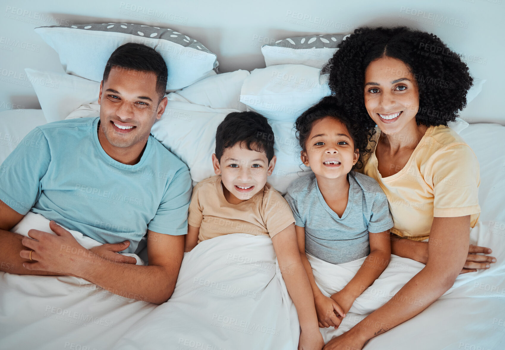 Buy stock photo Top view, bed and portrait of parents with children for bonding, quality time and affection in morning. Happy, family and above of mother, father and kids in bedroom for fun, sleeping and relaxing