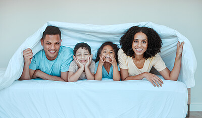 Buy stock photo Happy, blanket and portrait of family in bed for bonding, quality time and affection in morning. Parent, love and playful mother, father and kids in bedroom for having fun, sleeping and relaxing