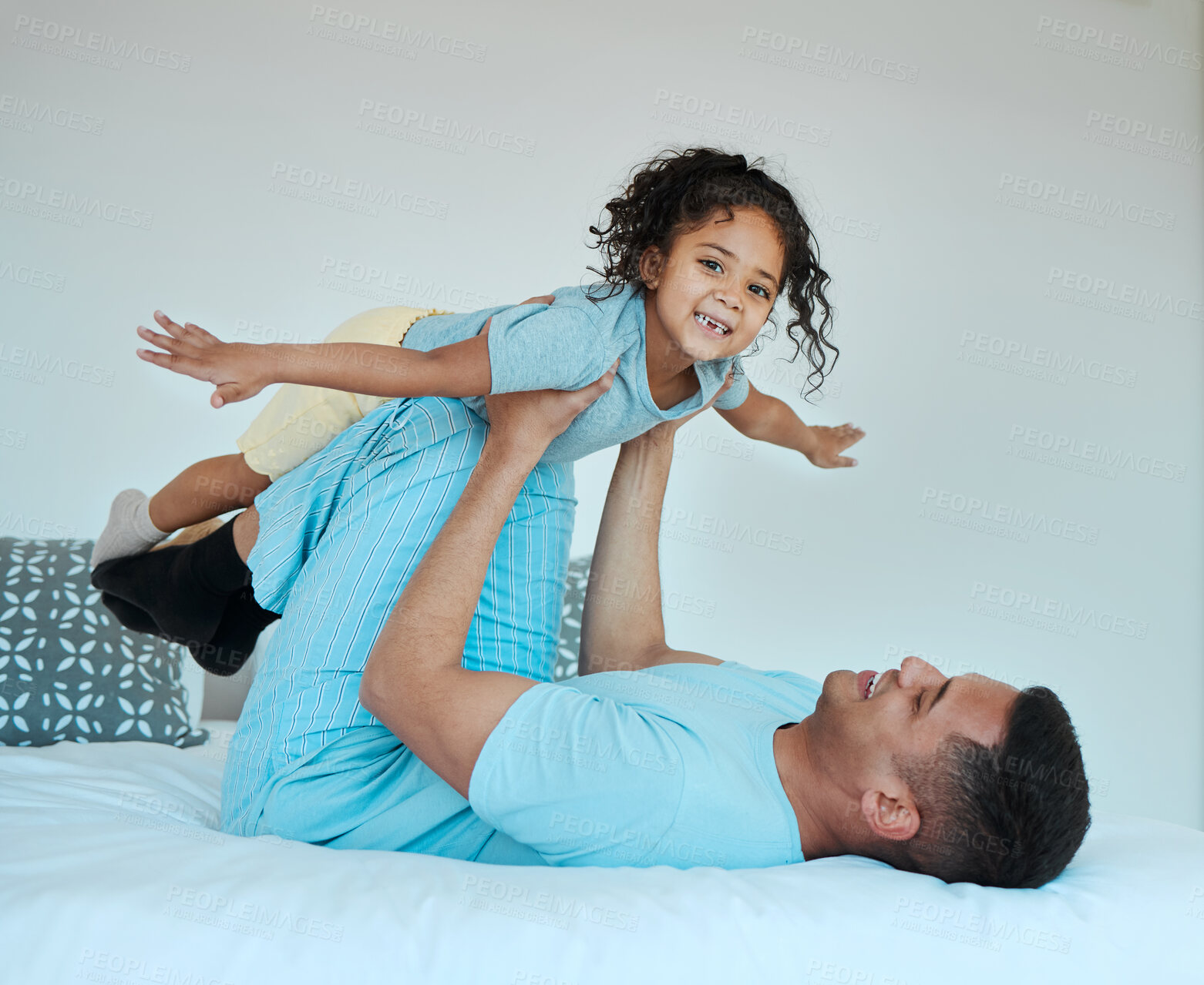 Buy stock photo Bedroom, airplane and portrait of father playing with child for quality time, fun or happiness at home. Happy, smile and young dad relaxing with boy kid in a superhero costume on bed at family house.