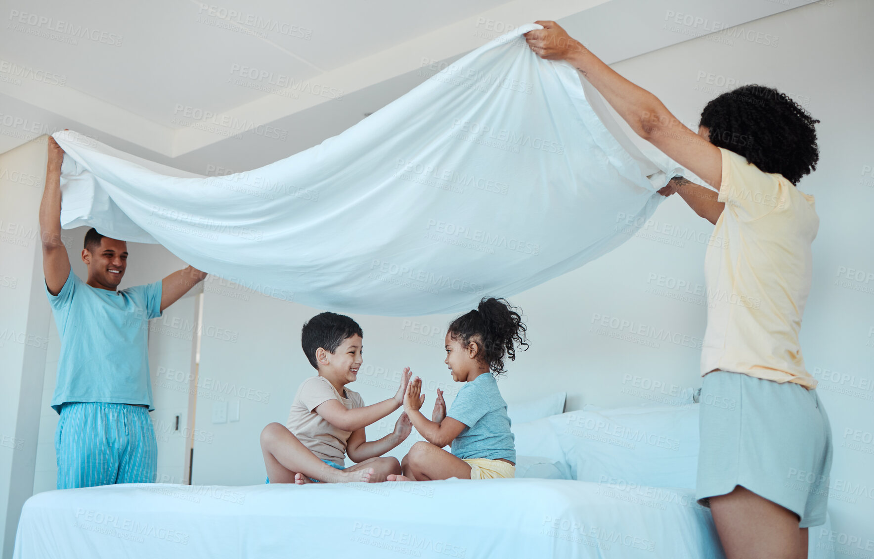 Buy stock photo Children, play and family with blanket in bedroom, bonding and smile together. Interracial, kids game and father and mother at bed with sheet for patty cake, happy and enjoying quality time in house