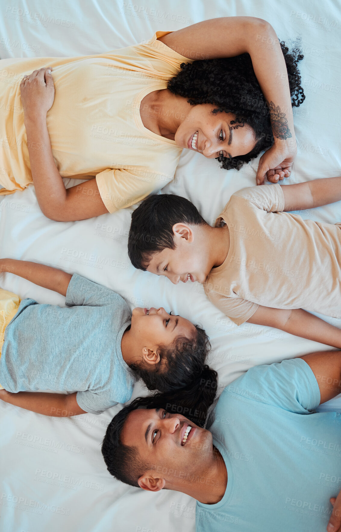 Buy stock photo Top view of mother, father and children in bed for bonding, quality time and affection in morning. Happy, love and above of mom, dad and kids in bedroom for fun, sleeping and relax together at home