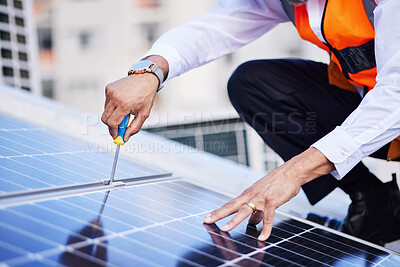 Buy stock photo Solar panels, person hands and screwdriver for engineering maintenance, sustainability and development on rooftop, Industry worker with eco friendly grid, tools and photovoltaic installation in city