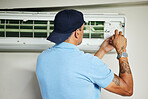 Man, electrician and ac repair for air conditioner maintenance from the back. Mechanic, technician and engineering tools to fix power of aircon machine, hvac services and check electrical ventilation