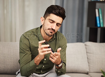 Buy stock photo Man, diabetes and blood sugar check with pen for healthcare and insulin monitor at home. Male person, medical test and glucose analysis in a living room with medicine, care and clinic tool in a house