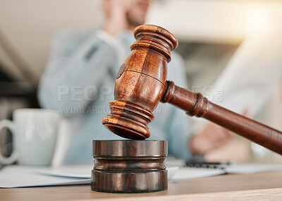 Buy stock photo Closeup, gavel and law on table, office and attorney man in blurred background with phone call for networking. Advocate, lawyer or judge with legal hammer, paperwork or documents for court evidence