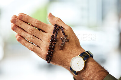 Christian man, rosary and hands praying for spiritual faith, holy gospel or worship God at church. Closeup, prayer beads and cross for support of religion, culture and praise of jesus, heaven or hope