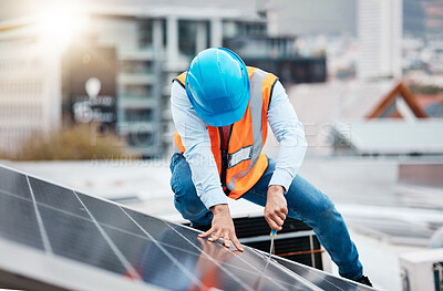 Buy stock photo Engineer man, screwdriver and solar panel on roof for maintenance, industry and construction in city. Technician, tools and photovoltaic system with helmet, development and renewable energy in cbd