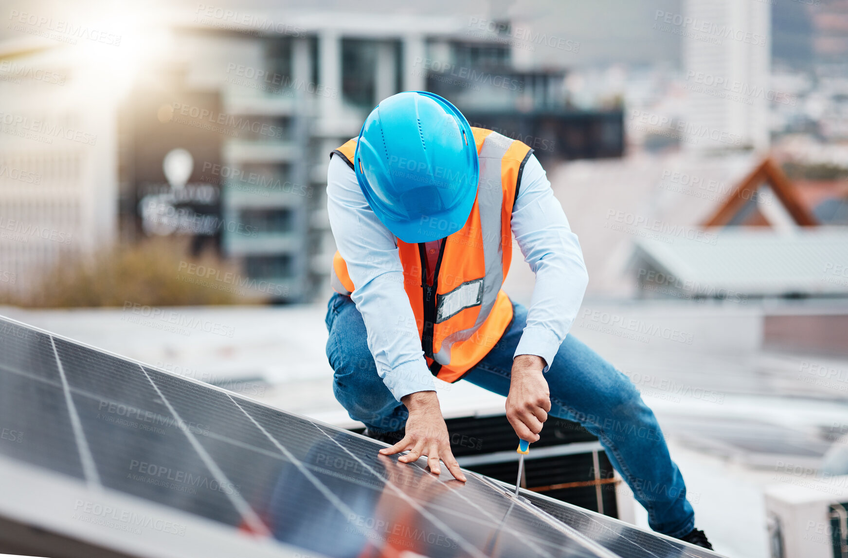 Buy stock photo Engineer man, screwdriver and solar panel on roof for maintenance, industry and construction in city. Technician, tools and photovoltaic system with helmet, development and renewable energy in cbd