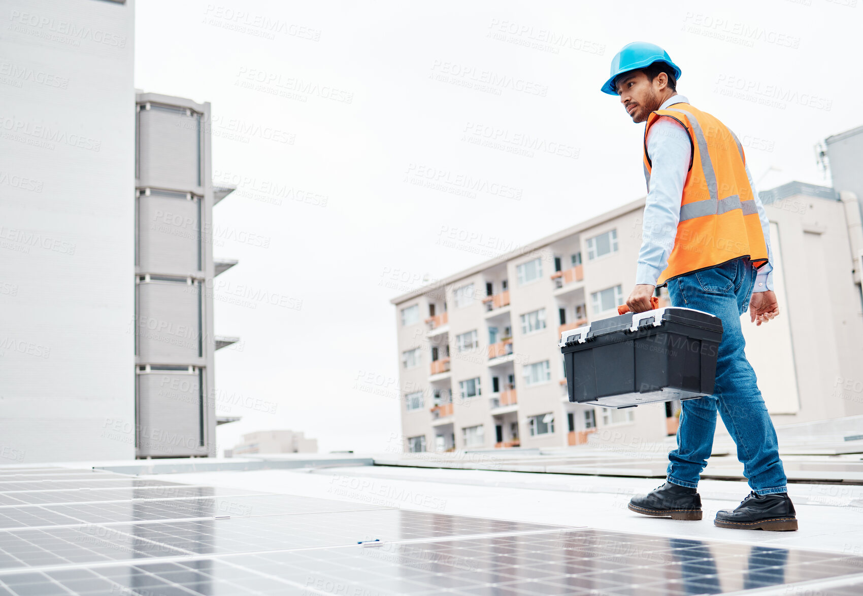 Buy stock photo Solar panel, tool box and engineering with man on roof top for renewable energy, project or power. Construction, electricity or technician with contractor in city for inspection and photovoltaic grid