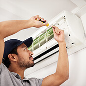 Air conditioner, man and electrical machine work with person in a home ...