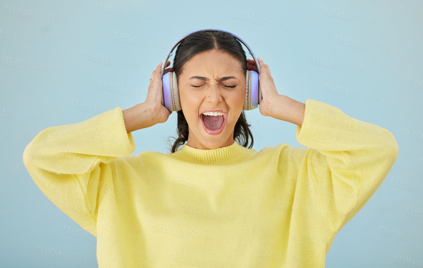 Buy stock photo Music, screaming and headphones with a woman in studio on a gray background while streaming audio. Radio, shouting or expression and an angry young female person listening to sound or loud noise