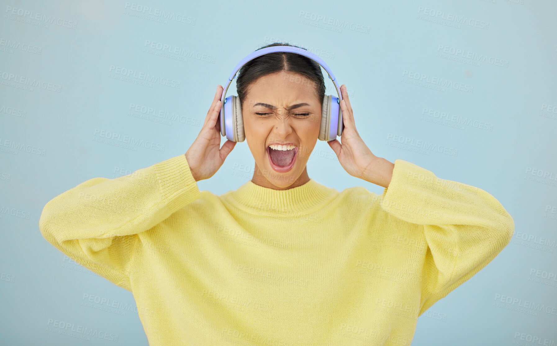 Buy stock photo Music, shouting and headphones with a woman in studio on a gray background while streaming audio. Radio, screaming or expression and a young person listening to sound or noise with her eyes closed
