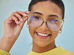 Woman portrait , glasses and vision with blue light frame with a smile with ophthalmology. Isolated, studio background and happy person with eye care, wellness and health of a girl with eyewear