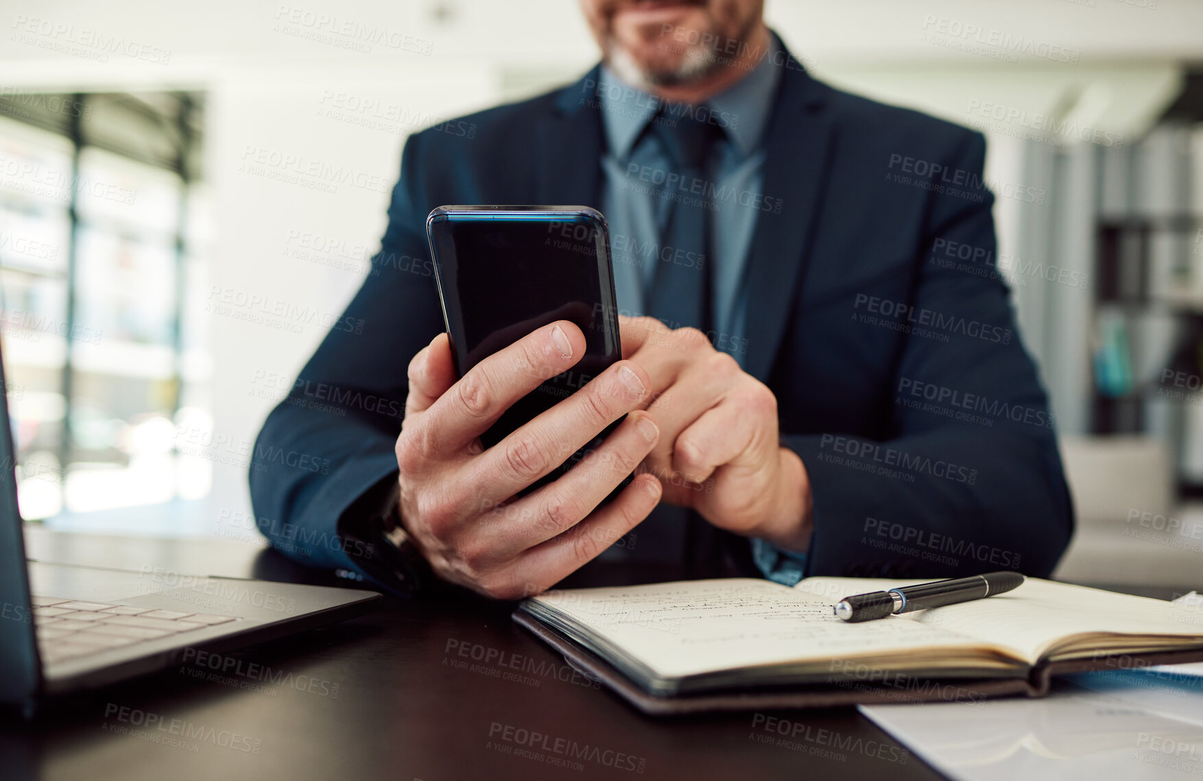 Buy stock photo Hands, phone and notebook with a business man checking his calendar while planning in an office. Mobile, communication or test message with an employee reading a schedule at his desk in the workplace
