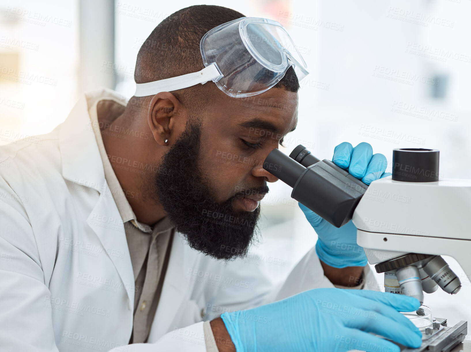 Buy stock photo Microscope, medical science and a man in a laboratory for research, study and analysis or focus. Face of a black person or scientist with a scope for innovation, biotechnology and future development