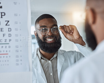 Buy stock photo Eye exam, smile and optometrist or man with glasses, confidence and happy service in consultation office. Ophthalmology, face in mirror and expert in vision, test or assessment for eyes or health